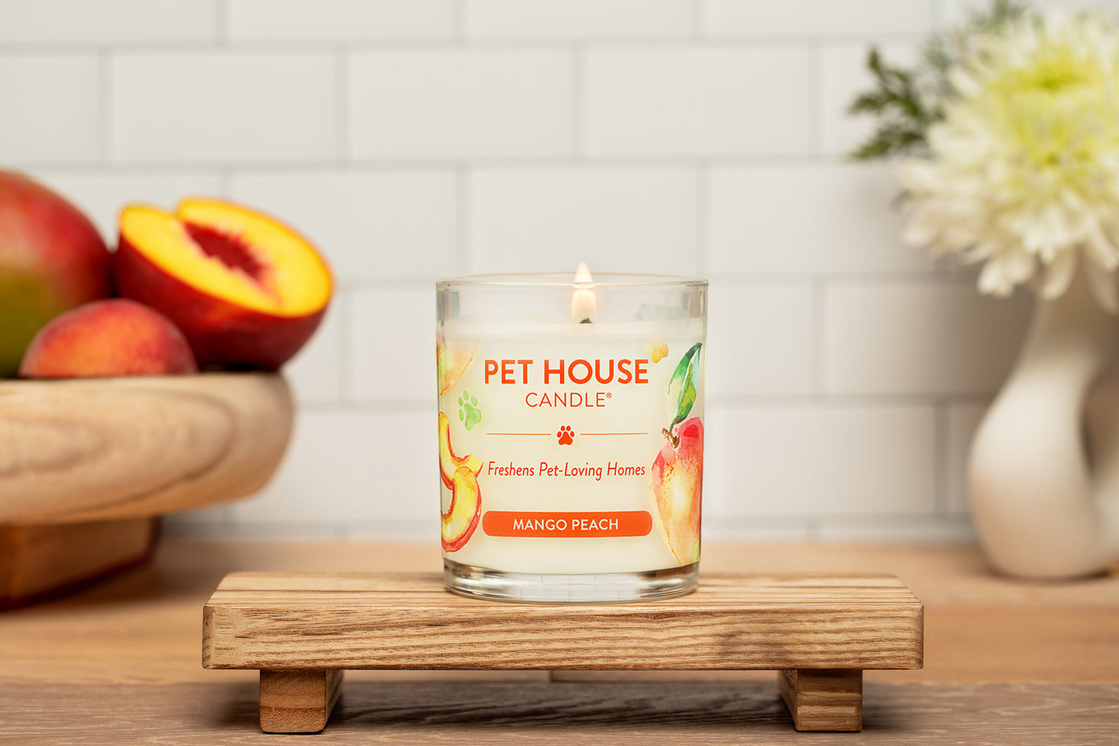 Mango Peach Candle on top of a small wooden table