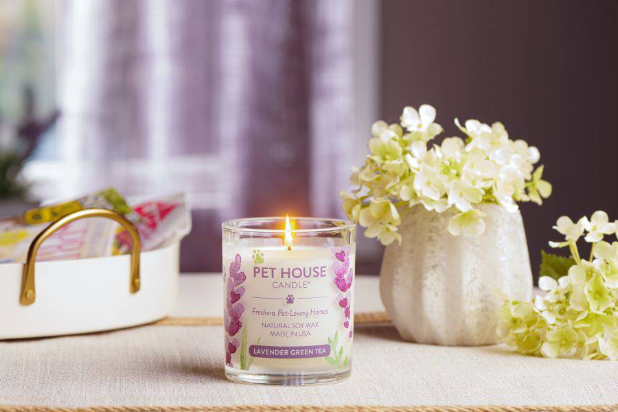 Lavender Green Tea Candle lit with white flowers
