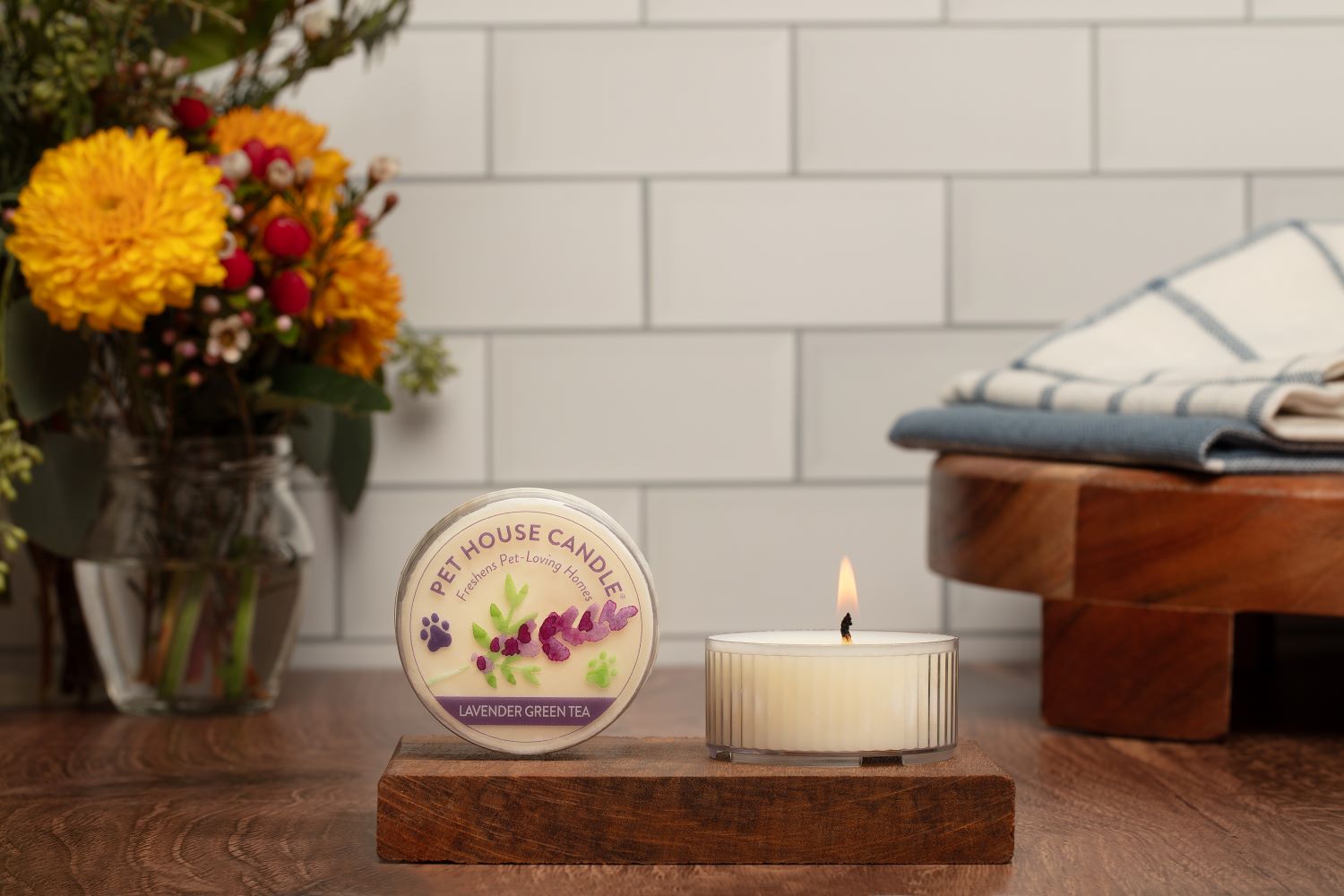 Lavender Green Tea Mini Candle on top of a small wood
