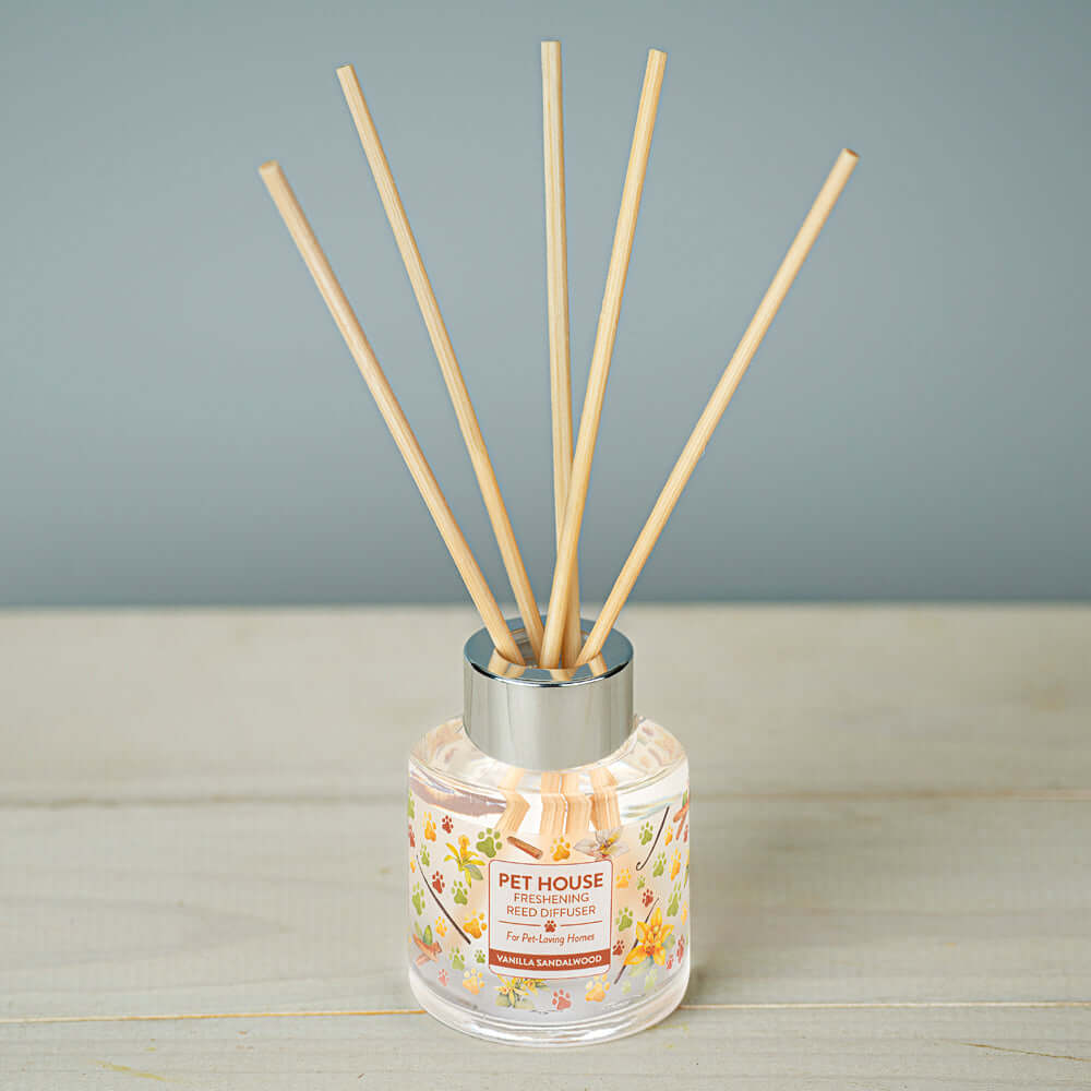 Vanilla Sandalwood Reed Diffuser with sticks on top of the table