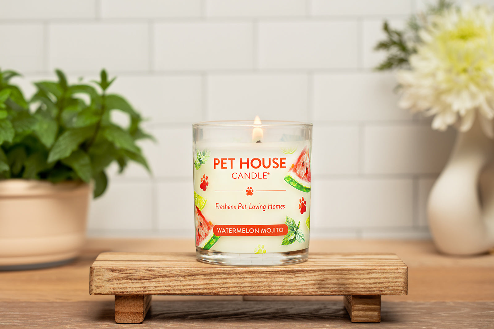 Watermelon Mojito Candle on top of a small wooden table