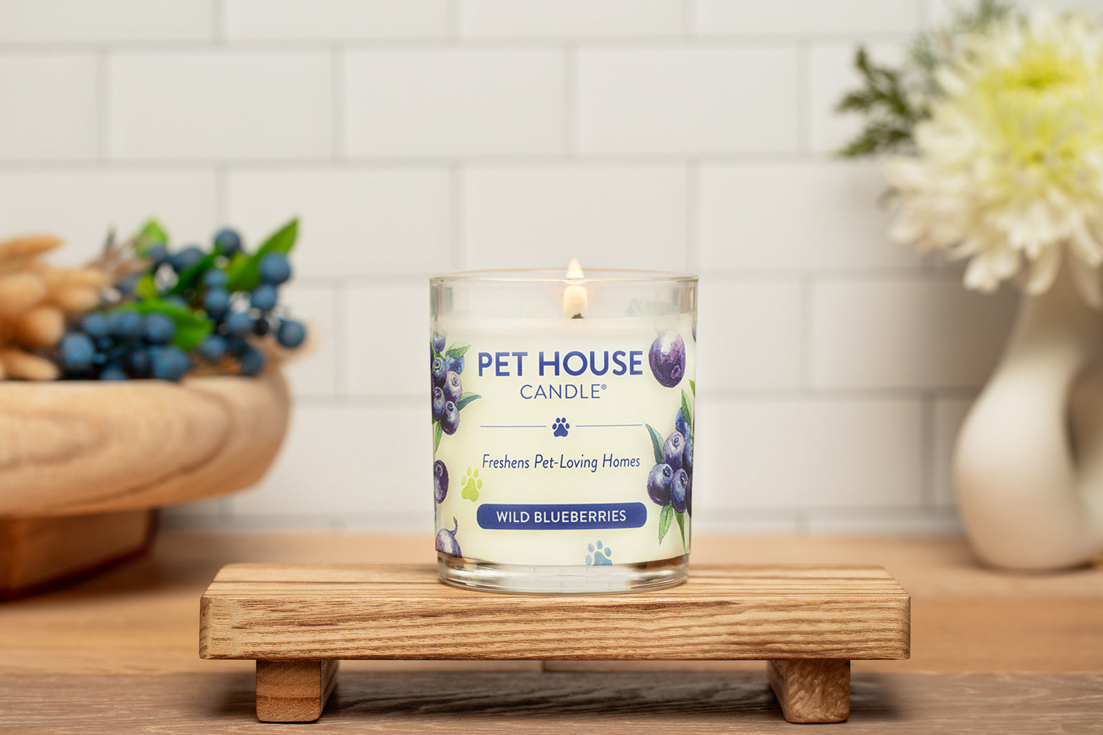 Wild Blueberries Candle on top of a small wooden table