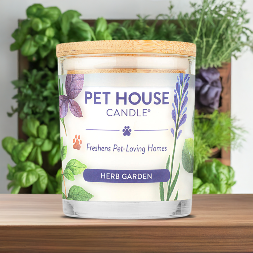 Herb Garden Pet House Candle in front of a wall garden with herbs