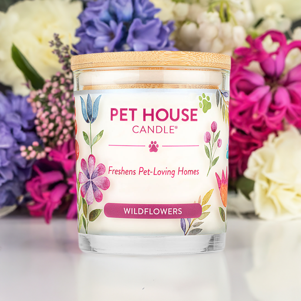 Pet House Wildflowers Candle with flowers in the background