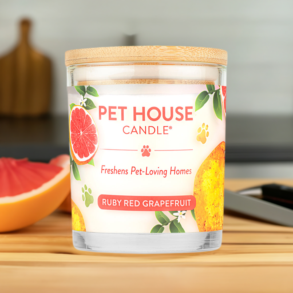 Ruby Red Grapefruit Pet House Candle on a cutting board